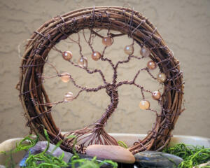 old grapevine wreath wrapped with rustic brown wire adorned with shades of brown glass beads 